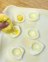 Dog-friendly deviled eggs being filled using a bag