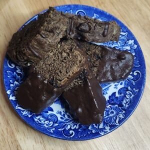 Carob biscotti for dogs on a blue plate.